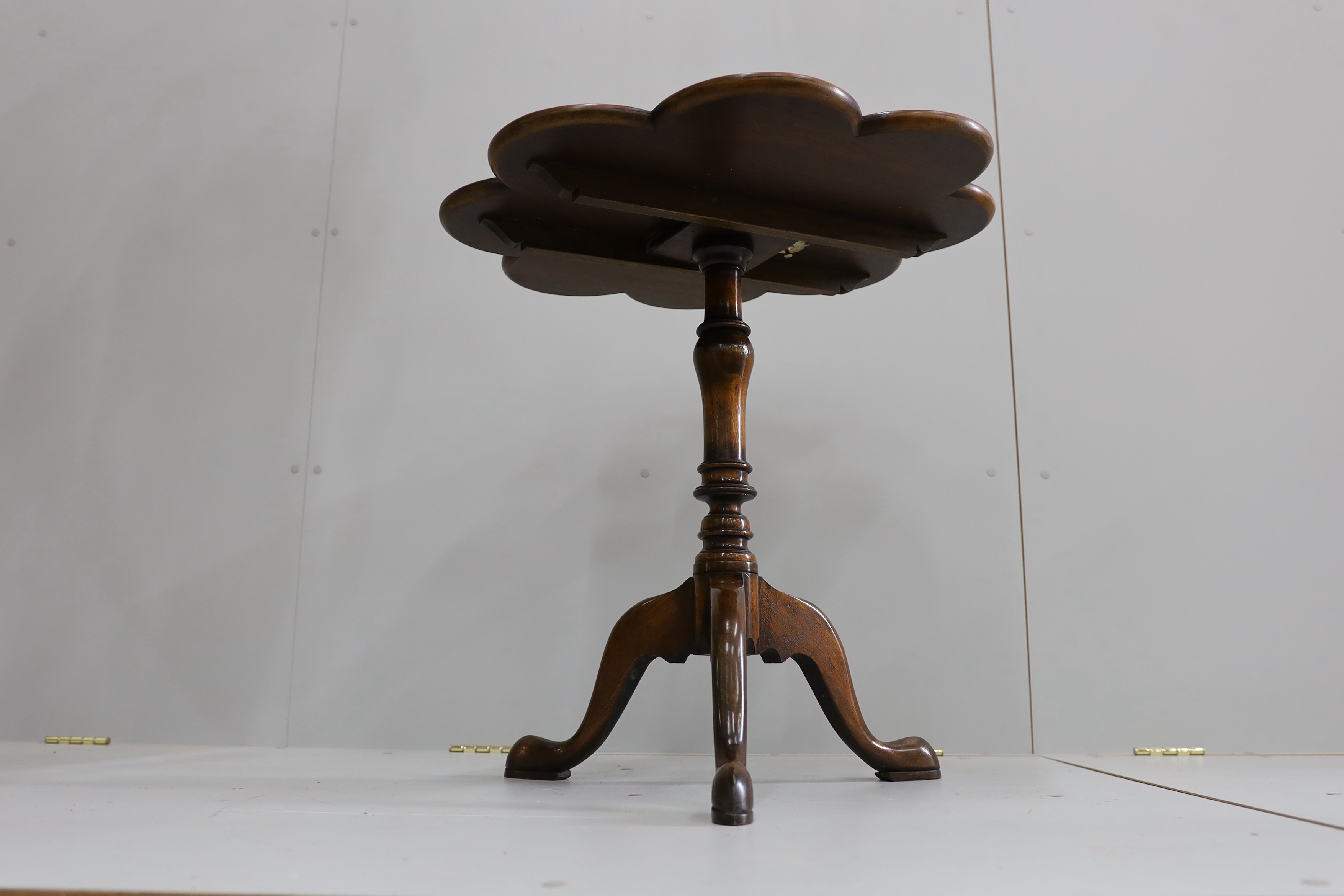 A pair of reproduction George III style mahogany and bird's eye maple tilt top tripod tea tables, width 68cm, height 69cm